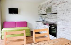 a room with a table and a chair and a kitchen at Awesome Apartment In Wagrain With Kitchen in Wagrain