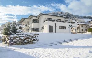 a white house in the snow with a driveway at Awesome Apartment In Wagrain With Kitchen in Wagrain