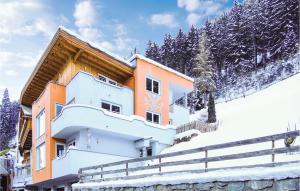 a building on a snow covered hill with trees at Gorgeous Apartment In Kappl With Kitchen in Kappl