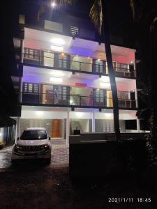 a car parked in front of a building at night at Raha homes in Trivandrum