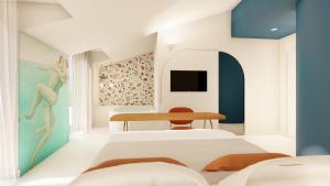 una camera con due letti e un tavolo di Albergo Dipinto BaccoFurore a Furore