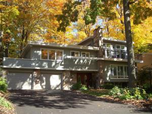 a large house with a balcony on top of it at Forest Hill Bed and Breakfast in Kitchener