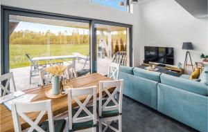 a living room with a blue couch and a table at Stunning Home In Ryn With Wifi in Ryn