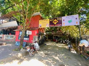 a motorcycle parked in front of a building at Ecran Riverfront Guesthouse in Kampot