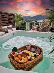 a basket of bread and food in a swimming pool at Villa Verde Bangalô - Garopaba - SC in Garopaba +36 photos