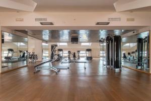 an empty gym with treadmills and elliptical machines at Plaza Caserta in Caserta