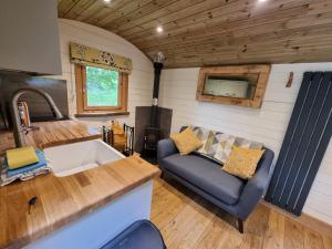 a kitchen and living room of a tiny house at Syke Farm Campsite - Yurt's and Shepherds Hut in Buttermere