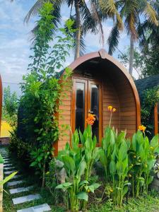 a small house with a door in a garden at BUNGALOW DANANG Healing Homestay 