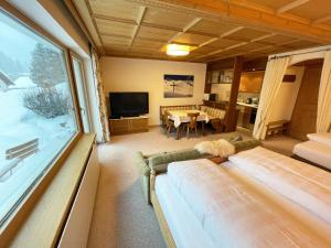 a living room with a couch and a large window at Alkira in Sankt Anton am Arlberg