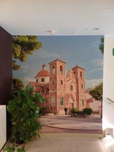 a picture of a building with a painting on the wall at Aureo Alojamiento Urbano in Abarán