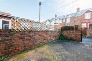 a brick wall in front of some houses at Prospect Terrace in New Brancepeth