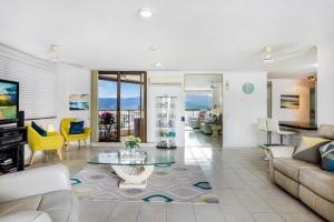 a living room with a couch and a table at Cairns Ocean View Apartment in Aquarius in Cairns