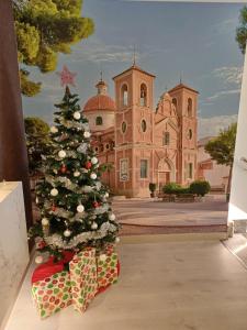 a christmas tree in front of a building at Aureo Alojamiento Urbano in Abarán