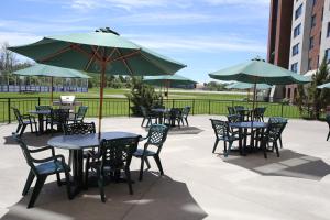 a group of tables and chairs with umbrellas at Residence & Conference Centre- Barrie in Barrie