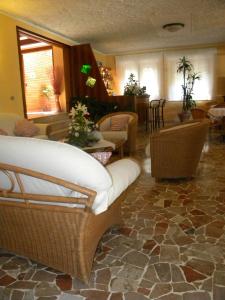 a living room with a couch and chairs at Hotel Rosa Del Tirreno in Quercianella