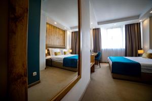 Postel nebo postele na pokoji v ubytování MARK Hotel