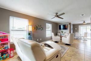 a living room with white furniture and a ceiling fan at Paradise Dream Vacations #2 in Indialantic
