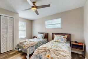 a bedroom with two beds and a ceiling fan at Paradise Dream Vacations #2 in Indialantic