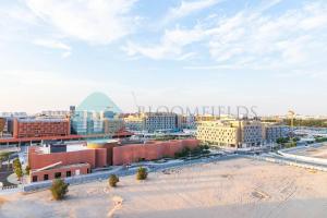 an aerial view of a city with buildings at Spacious 2 Bedroom In Oasis in Al Qurayyah