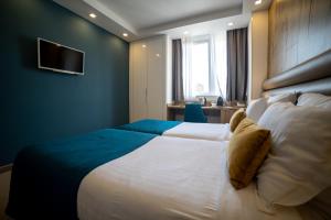Postel nebo postele na pokoji v ubytování MARK Hotel