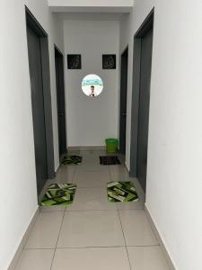 a hallway with black doors and a white tile floor at Putrajaya Homestay (Zurinn 2) in Putrajaya