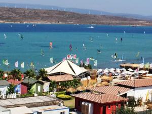 a beach with a bunch of people in the water at Alacati Eldoris Butik Hotel in Alacati