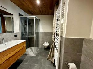 a bathroom with a sink and a shower and a toilet at Alpine Escape 3 in Bormio