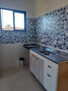 a kitchen with a sink and a window at Pousada Vista da Lagoa in Florianópolis