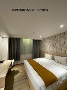 a bedroom with a large bed in a room at Hotel Lereng Bromo in Pasuruan