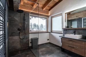 a bathroom with a shower and a sink at Big Seven Ferienwohnungen Seiwald in Fieberbrunn +89 photos