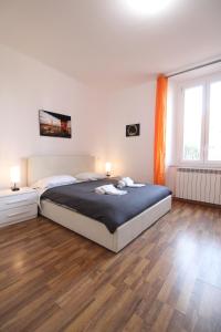 a bedroom with a large bed and a large window at the house outside the walls in Siena