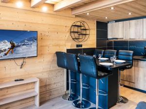Un comedor con una mesa y un televisor. en Appartement montagne rénové, 6 pers, proche pistes et commodités - FR-1-637-59, en Val Thorens