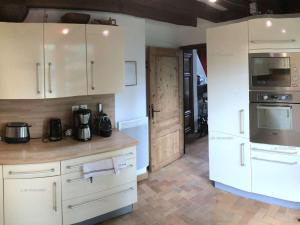 a kitchen with white cabinets and a counter top at Chalet Les Orres, 4 pièces, 11 personnes - FR-1-322-581 in Les Orres