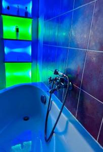 a bathroom with a bath tub with a hose at 300m od Rynku Sinus Apartaments in Wejherowo