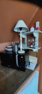 a table with a lamp on top of a microwave at Heerlijke Studio in centrum van Brugge in Bruges