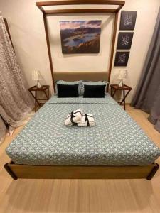 a bedroom with a bed with shoes on it at TimurBay Seafront ZarZyra Suite in Kuantan +11 photos