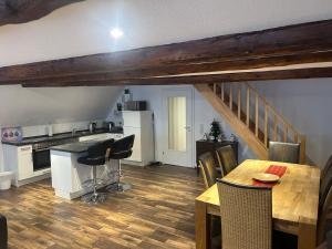 a kitchen and dining room with a table and chairs at Hotel Kammerkrug in Bad Harzburg