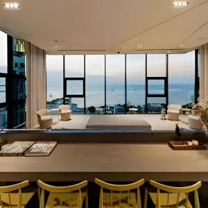 a room with a view of a living room with chairs at THE BASE apartments at central pattaya in Pattaya Central