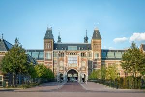 un gran edificio de ladrillo con una gran puerta en Hotel City Garden Amsterdam en Ámsterdam