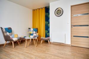 a room with two chairs and a table and a door at Superbe grange réaménagée in Fampoux