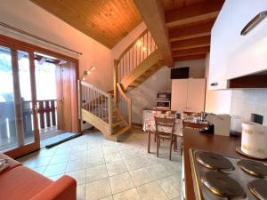 a kitchen with a staircase and a living room at Affittimoderni San Simone - VALS30 in Valleve