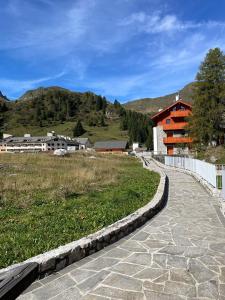 a stone walkway leading to a building in a field at Affittimoderni San Simone - VALS30 in Valleve