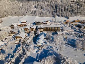 una vista aérea de un complejo cubierto de nieve en LACUS Hotel am See, en Weissensee