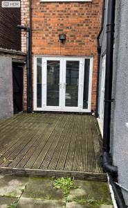 a door to a building with a wooden deck at Melior Grandiose in Liverpool