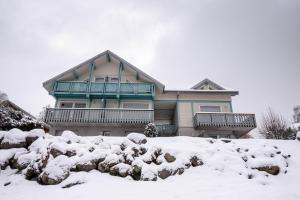 a house with snow in front of it at Les Adrets in Gérardmer