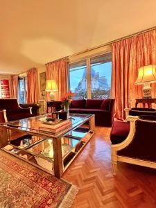 a living room with a glass table and a couch at Paris luxury apartment in Paris +51 photos