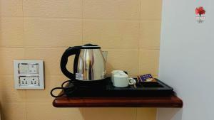 a coffee maker sitting on a table with a cup at PANSHET VALLEY RESORT- MTDC & Agro Tourism in Pune