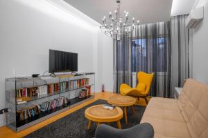 a living room with a couch and a tv at Central Luxurious 2 BD Flat near NDK in Sofia