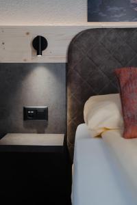 Ένα ή περισσότερα κρεβάτια σε δωμάτιο στο Hotel Central Wolter - Grindelwald