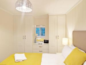 a bedroom with a bed and a sink in it at Elm Lodge in Bosham +13 photos